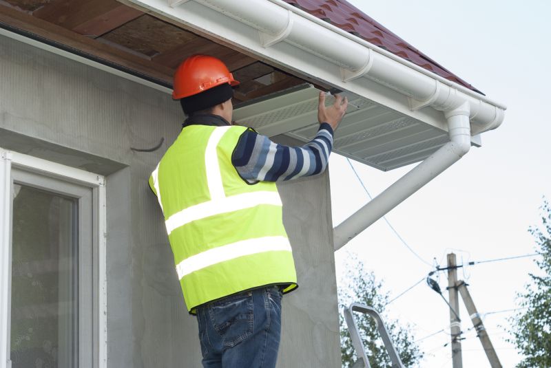 Worker repairing eaves